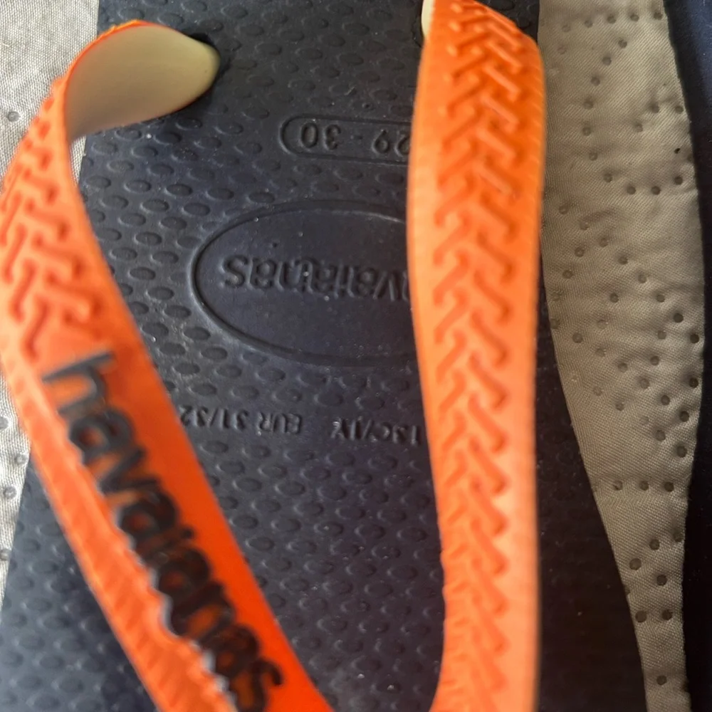 Havana’s flip flops size 29/30 (11-12). Navy base w/orange strap. Great shape!